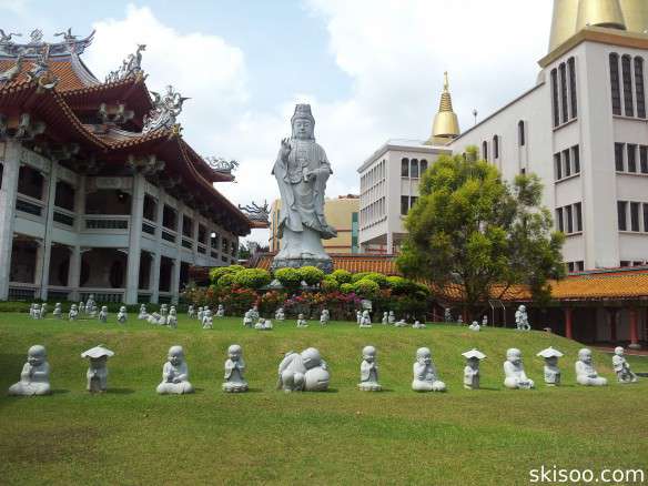 Statue of Guanyin and Bouddhas on the grass